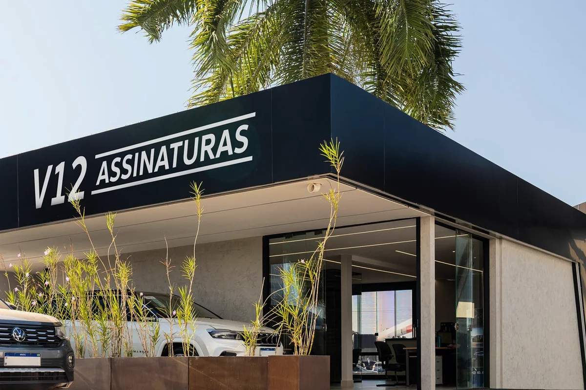 Fachada da loja V12 Assinaturas, com carros 0km no showroom